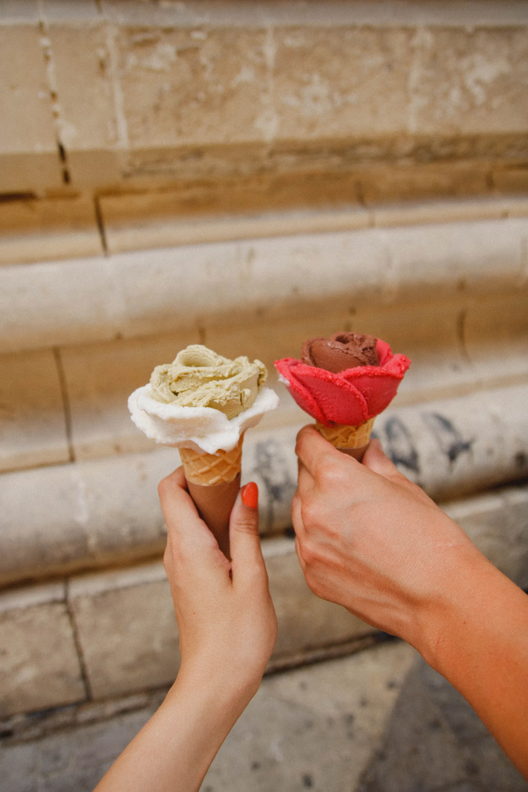 Two berry-coloured gelato cones