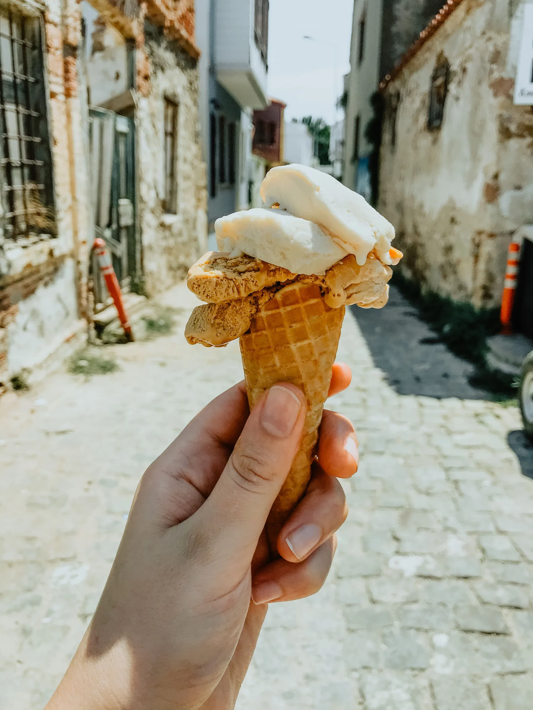 Pale gelato in a cone outdoors